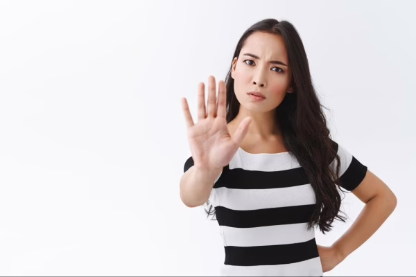 Orang yang sedang menunjukan tangan menandakan stop